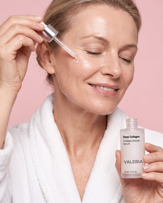 Woman applying Deep Collagen Booster Serum